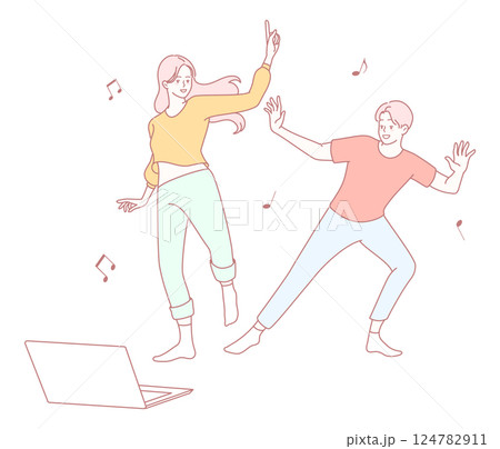 Young people dancing joyfully at home while using their laptops and enjoying music and fun 124782911