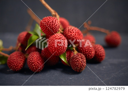 Fresh red lychee fruits with leaves Fresh red lychee fruits with leaves 124782979