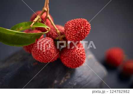 Fresh red lychee fruits with leaves Fresh red lychee fruits with leaves 124782982