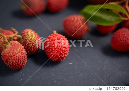 Fresh red lychee fruits with leaves Fresh red lychee fruits with leaves 124782992