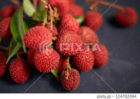 Fresh red lychee fruits with leaves Fresh red lychee fruits with leaves 124782994