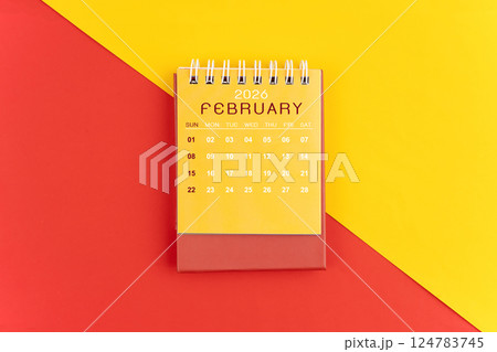 February 2026 desk calendar on red and yellow background. 124783745