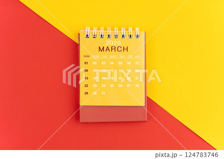 March 2026 desk calendar on red and yellow background. March 2026 desk calendar on red and yellow background. 124783746