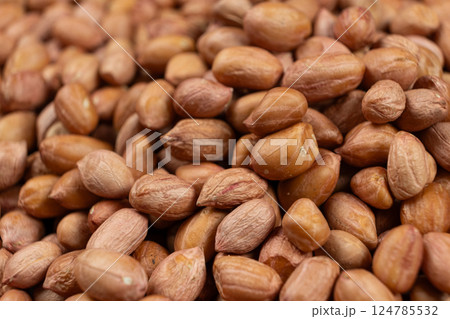 Peanut background, lots of raw peeled brown peanuts close-up. Peanut background, lots of raw peeled brown peanuts close-up. 124785532