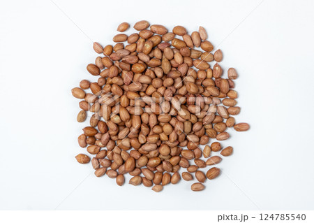 Raw brown peanuts close-up view from above on white background Raw brown peanuts close-up view from above on white background 124785540