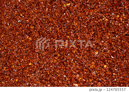 Deep red chili pepper powder close-up texture top view 124785557
