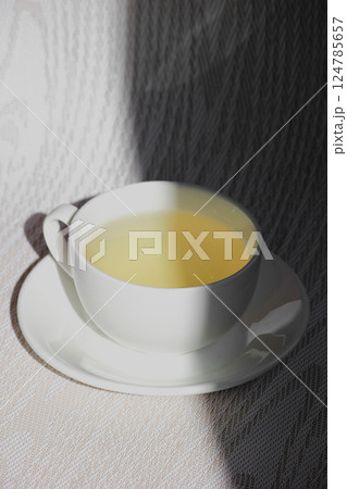 White cup and saucer with mint tea 124785657