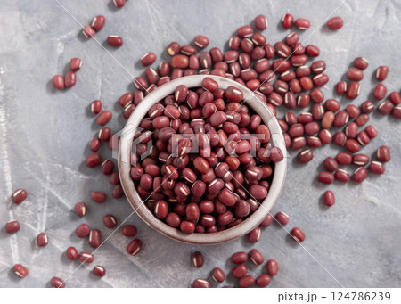 Bowl full of dried azuki beans on gray top view. East Asian legumes, vegetarian protein source 124786239