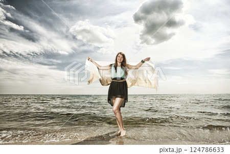 young beautiful woman portrait on the beach 124786633