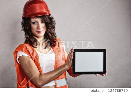 Sexy girl in safety helmet showing tablet 124786759