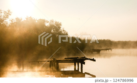 Piers and fog over the lake at dawn in summer Piers and fog over the lake at dawn in summer 124786996
