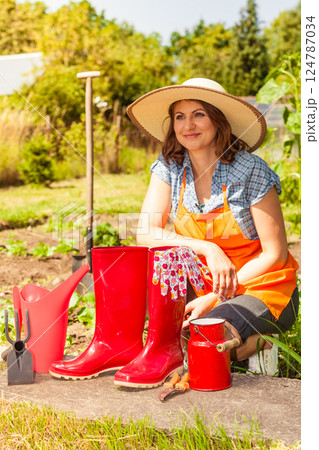 Female farmer and gardening tools in garden 124787034