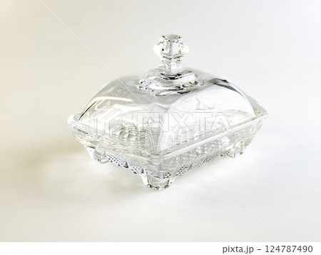 Glass container for storing butter on white background. Glass container for storing butter on white background. 124787490
