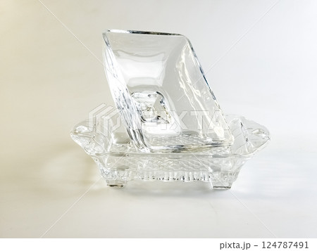 Glass container with lid for storing butter on white background. Glass container with lid for storing butter on white background. 124787491