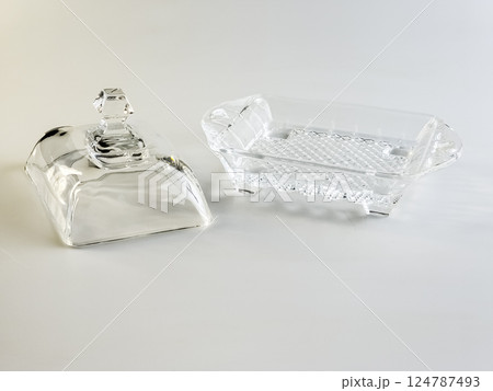 Glass container for storing butter on a white background. Glass container for storing butter on a white background. 124787493