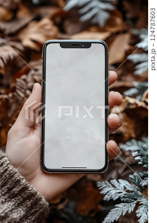 Persons hand holding a smartphone with a blank screen, perfect for app previews, social media ads Persons hand holding a smartphone with a blank screen, perfect for app previews, social media ads 124787603