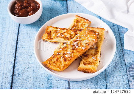 Golden sweet croutons of bread on a plate on the table Golden sweet croutons of bread on a plate on the table 124787656