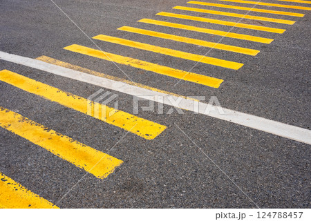 Yellow and black pedestrian zebra crosswalk markings on asphalt road Yellow and black pedestrian zebra crosswalk markings on asphalt road 124788457