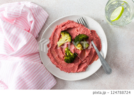 A balanced breakfast with beetroot hummus and broccoli, offering a wholesome start to the day A balanced breakfast with beetroot hummus and broccoli, offering a wholesome start to the day 124788724