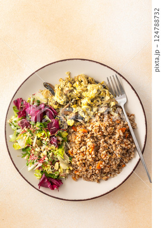 Buckwheat porridge with mixed salad and fried mushrooms with eggs Buckwheat porridge with mixed salad and fried mushrooms with eggs 124788732