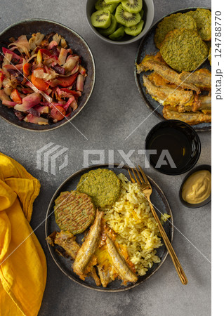 A savory, balanced breakfast with turmeric rice, baked ocean fish, broccoli pancakes, and roasted vegetable salad, providing essential proteins and healthy fats for an energizing start A savory, balanced breakfast with turmeric rice, baked ocean fish, broccoli pancakes, and roasted vegetable salad, providing essential proteins and healthy fats for an energizing start 124788770