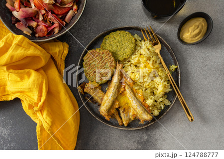A savory, balanced breakfast with turmeric rice, baked ocean fish, broccoli pancakes, and roasted vegetable salad, providing essential proteins and healthy fats for an energizing start A savory, balanced breakfast with turmeric rice, baked ocean fish, broccoli pancakes, and roasted vegetable salad, providing essential proteins and healthy fats for an energizing start 124788777