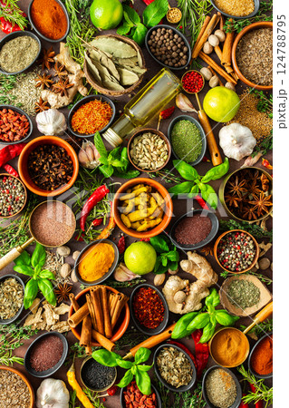 A colorful assortment of fragrant herbs and spices on a warm brown background, showcasing their visual variety and aromatic appeal A colorful assortment of fragrant herbs and spices on a warm brown background, showcasing their visual variety and aromatic appeal 124788795