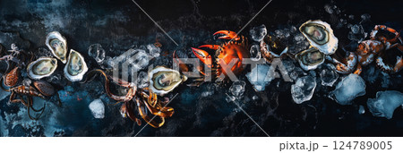 A premium seafood platter with oysters, crab, and squid on a deep blue background, enhanced by ice chunks and soft lighting, creating a refined and appetizing gourmet scene, banner 124789005