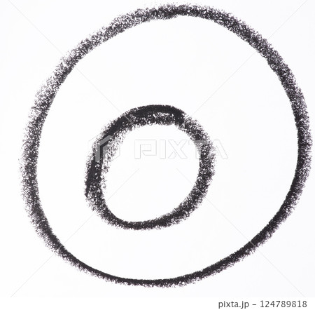 Two concentric circles drawn with thick black crayon on a white background. The crayon texture is visible, giving the circles a hand drawn 124789818
