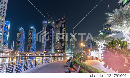 Run on promenade of Dubai Marina with view of towers and canal in Dubai night timelapse hyperlapse Run on promenade of Dubai Marina with view of towers and canal in Dubai night timelapse hyperlapse 124791601