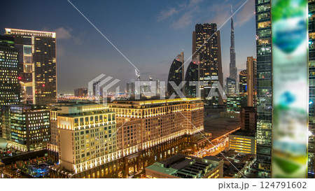 Downtown Dubai towers day to night timelapse. Aerial view of Sheikh Zayed road with skyscrapers after sunset. Downtown Dubai towers day to night timelapse. Aerial view of Sheikh Zayed road with skyscrapers after sunset. 124791602