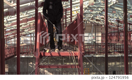 Welder working with electrode at semi-automatic arc welding in manufacture production plant timelapse 124791956