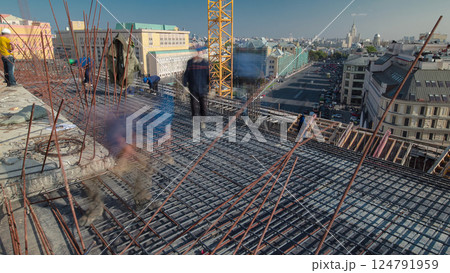 Construction workers working on steel rods used to reinforce concrete timelapse 124791959