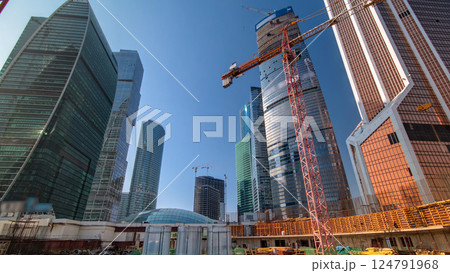 Tower cranes on construction site surrounded by skyscrapers timelapse. Tower cranes on construction site surrounded by skyscrapers timelapse. 124791968