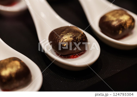 Elegant gourmet chocolate truffles with a touch of edible gold dust, 124793304