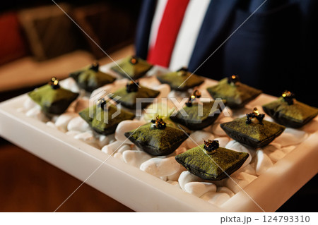 Luxurious matcha-infused dessert with a velvety green coating Luxurious matcha-infused dessert with a velvety green coating 124793310