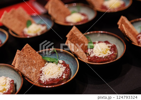 Exquisite beef tartare elegantly presented in ceramic bowls Exquisite beef tartare elegantly presented in ceramic bowls 124793324