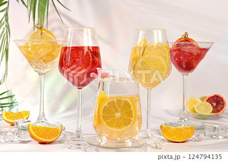 Cocktails from fruits, ice cubes, rum and tequila. Banner with various glasses of alcoholic drinks and tropical fruits. Summer party and relaxation concept. Menu for a bar or cafe. Cocktails from fruits, ice cubes, rum and tequila. Banner with various glasses of alcoholic drinks and tropical fruits. Summer party and relaxation concept. Menu for a bar or cafe. 124794135