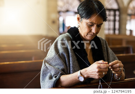 Pray, senior woman and praying in church with a rosary for religion, worship and God praise, peaceful and calm. Holy, peace and prayer by Mexican female in chapel in Mexico for spiritual blessing 124794195