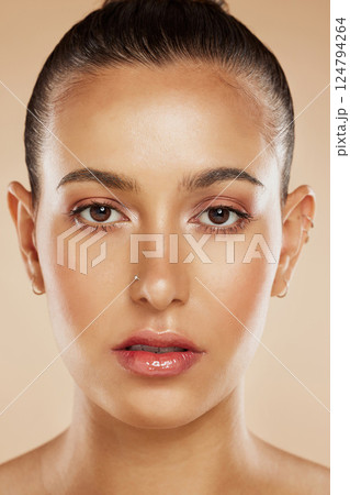 Portrait of woman, beauty and face skincare for luxury spa healthy hair cosmetics wellness. Young girl, beautiful model and natural happy smile or hair care makeup in orange background studio. 124794264
