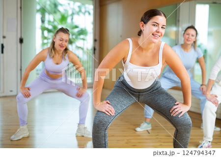 Active young woman practicing aerobic dance in training hall Active young woman practicing aerobic dance in training hall 124794347