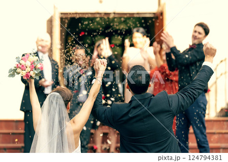 Wedding, applause and couple holding hands in celebration with support from clapping guests, friends and family. Back view, bride and groom celebrate trust, hope and success in love at a social event 124794381