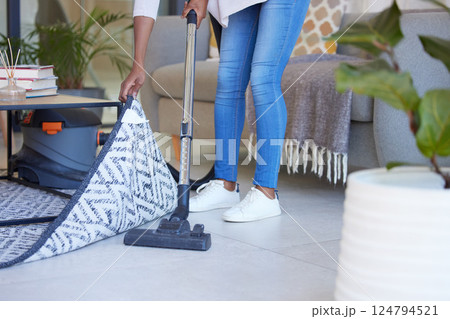 Cleaning, carpet and vacuum with black woman in living room for dust, furniture or housekeeping service. Electric, dirt and cleaner with shoes of housewife and floor at home for hygiene and lifestyle Cleaning, carpet and vacuum with black woman in living room for dust, furniture or housekeeping service. Electric, dirt and cleaner with shoes of housewife and floor at home for hygiene and lifestyle 124794521
