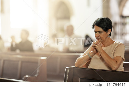 Senior woman praying in church, worship and trust God, prayer or spiritual respect. Christian woman praise in holy temple of religion, faith and sunday congregation for bible service, peace and grace 124794615