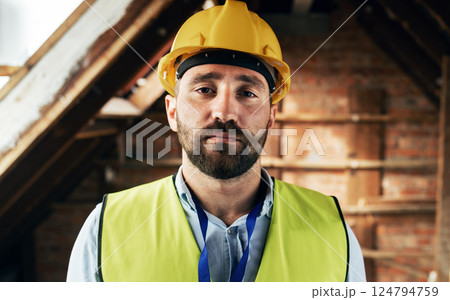 Man face, architect or construction worker, engineer at work site and business, building trade industry portrait. Mature person, safety helmet and professional, engineering and construction job 124794759