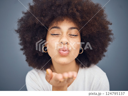 Kissing, love and romance with a black woman blowing a kiss in studio on a gray background for romantic affection. Beauty, lips and flirt with an attractive young female making a mouth gesture Kissing, love and romance with a black woman blowing a kiss in studio on a gray background for romantic affection. Beauty, lips and flirt with an attractive young female making a mouth gesture 124795137