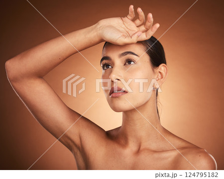Beauty, skincare, and health of a woman with hand on head for wellness, self care and and self love of body and mind. Girl model with glow in studio from makeup, cosmetics and dermatology mockup 124795182