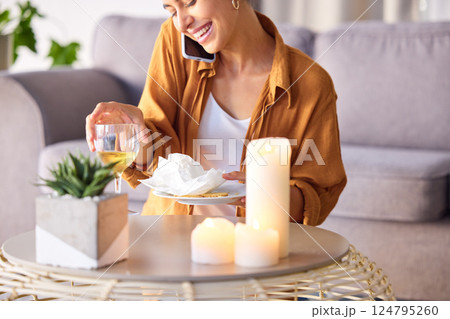 Woman, candles and phone call with smile, happy and content being peaceful, relax or in living room. Female, light and smartphone for conversation, champagne and talking for joy or cheerful in lounge 124795260