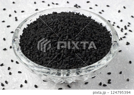 black cumin Nigella sativa in glass bowl on grey kitchen table black cumin Nigella sativa in glass bowl on grey kitchen table 124795394