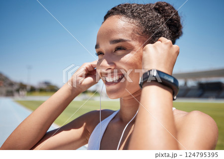 Face, music and fitness with a black woman runner or athlete listening to audio during endurance training. Workout, earbuds and exercise with a female getting ready for a run on a sports track Face, music and fitness with a black woman runner or athlete listening to audio during endurance training. Workout, earbuds and exercise with a female getting ready for a run on a sports track 124795395